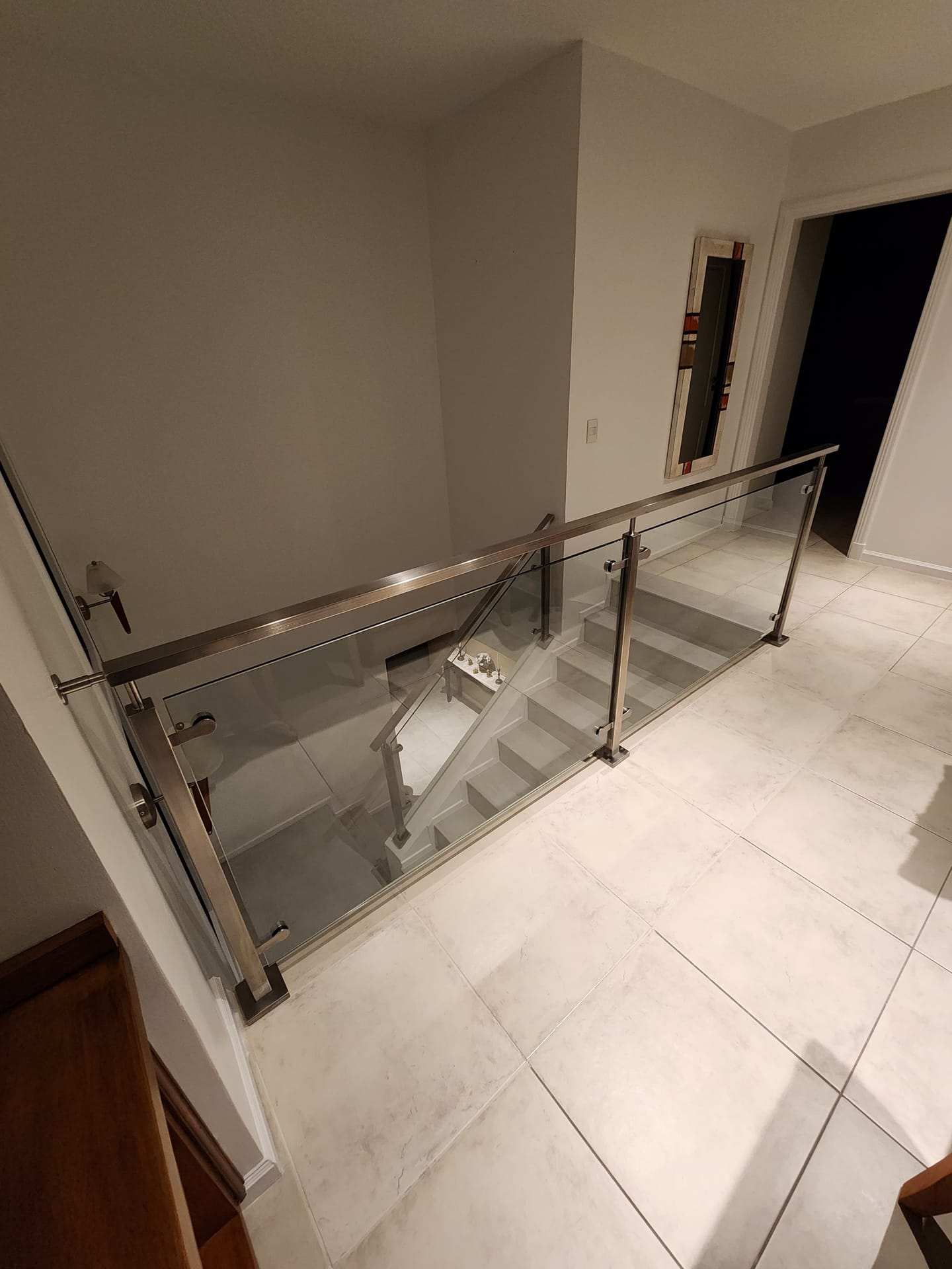 Escalera con baranda de acero inoxidable y vidrio en vivienda de Talar del Lago 2